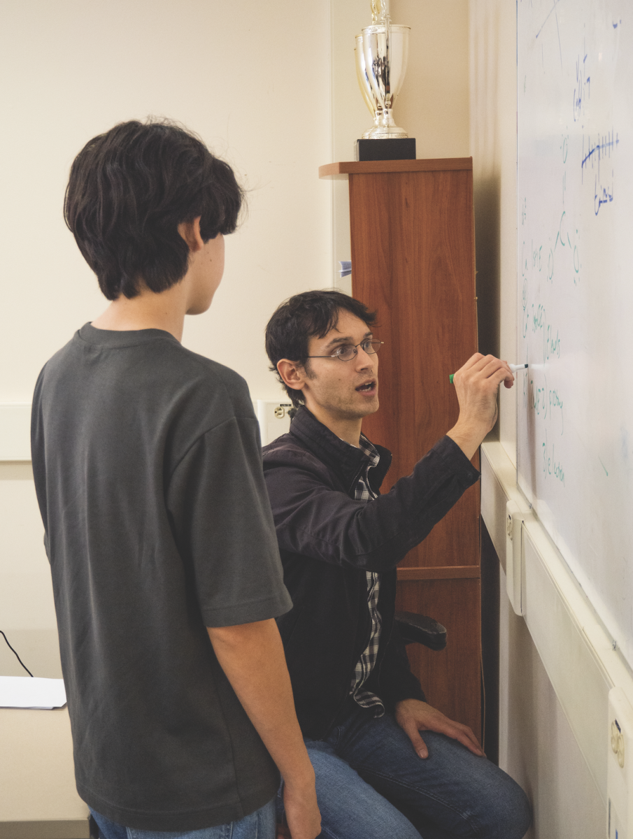 Science teacher Samuel Howles-Banerji explains ionization energy to a chemistry student.